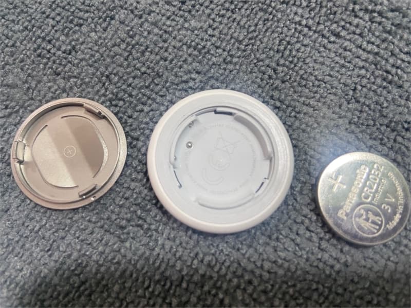 Airtag with back cover and battery removed