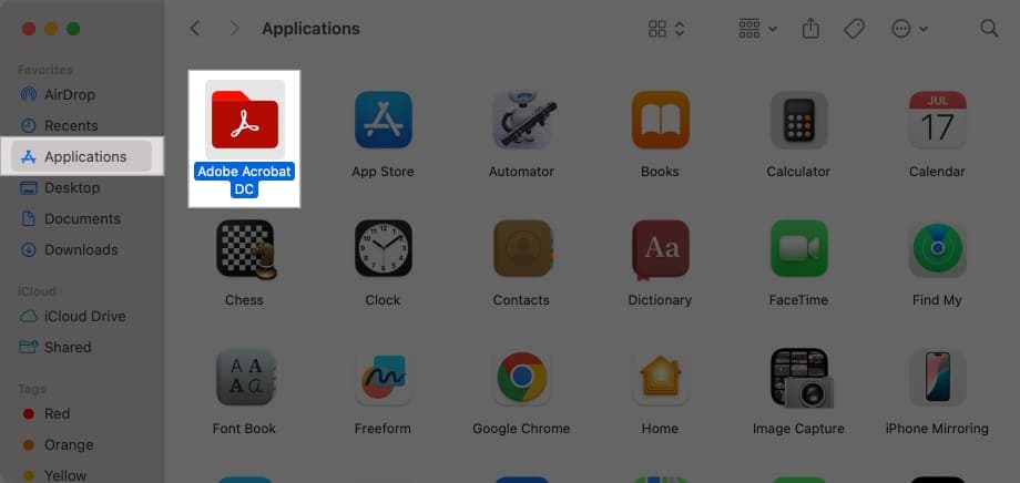 Dragging an app in Finder to Trash to delete it.