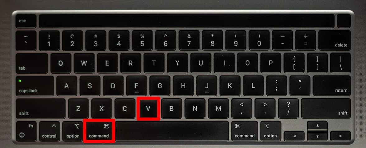 Pressing the Command+V keys on a keyboard.