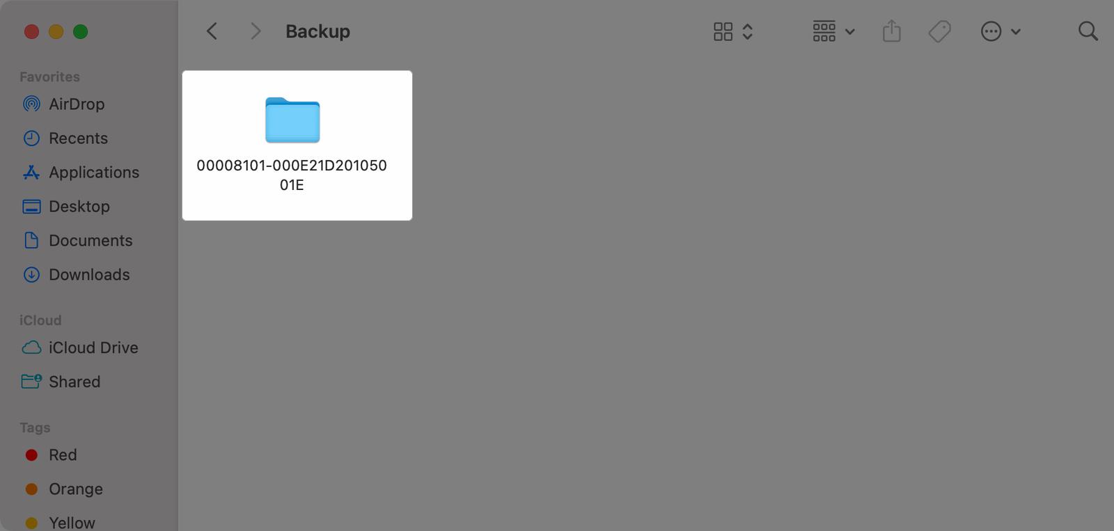 Choosing the iPhone backup folder to delete in Finder on a Mac.