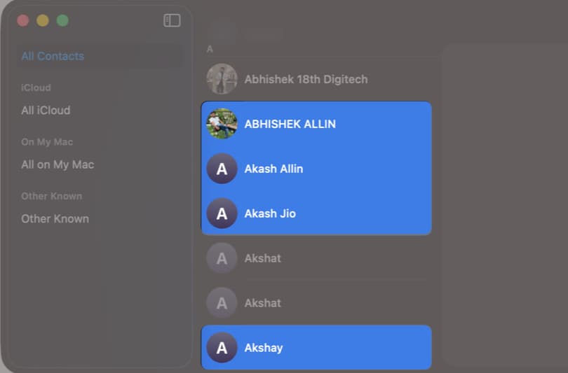 Command (⌘) + click to select multiple contacts.
