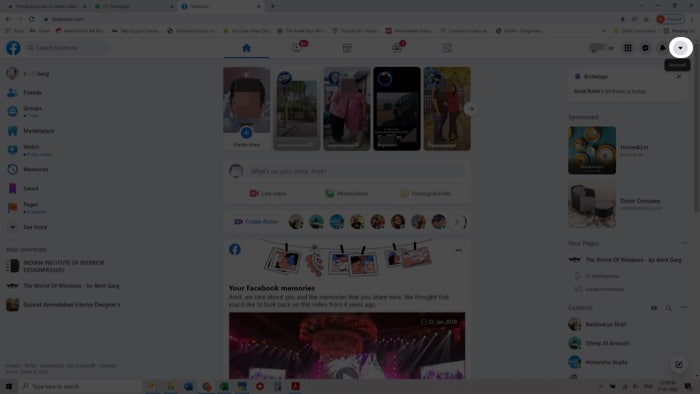 Tap the down arrow icon at the top right in FaceBook on Desktop