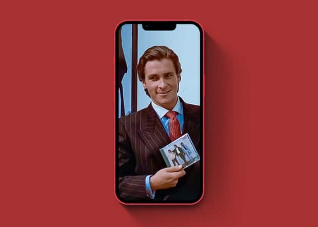 Christian bale psycho smiling holding a cd drive