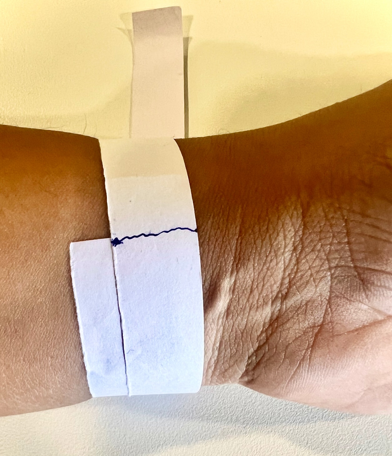 Measure your wrist with a ruler, paper, and pen