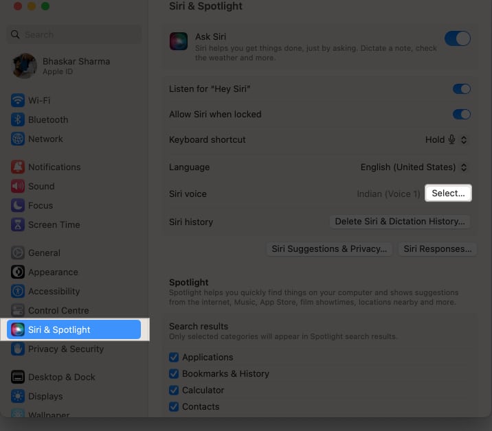 Head to System Settings, Siri & Spotlight, and click the Select button next to Siri Voice