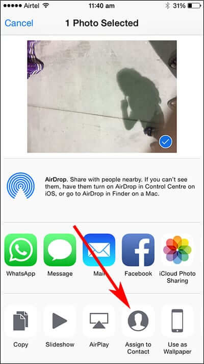 Tap Assign to Contact in iPhone Photos App Share Sheet