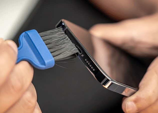 Cleaning iPhone charging port with a soft brush