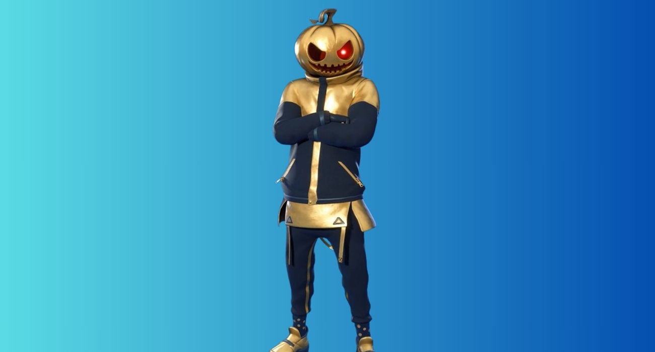 Cosplay-style character in a gold pumpkin mask and blue-gold outfit, arms crossed, on a blue gradient background.