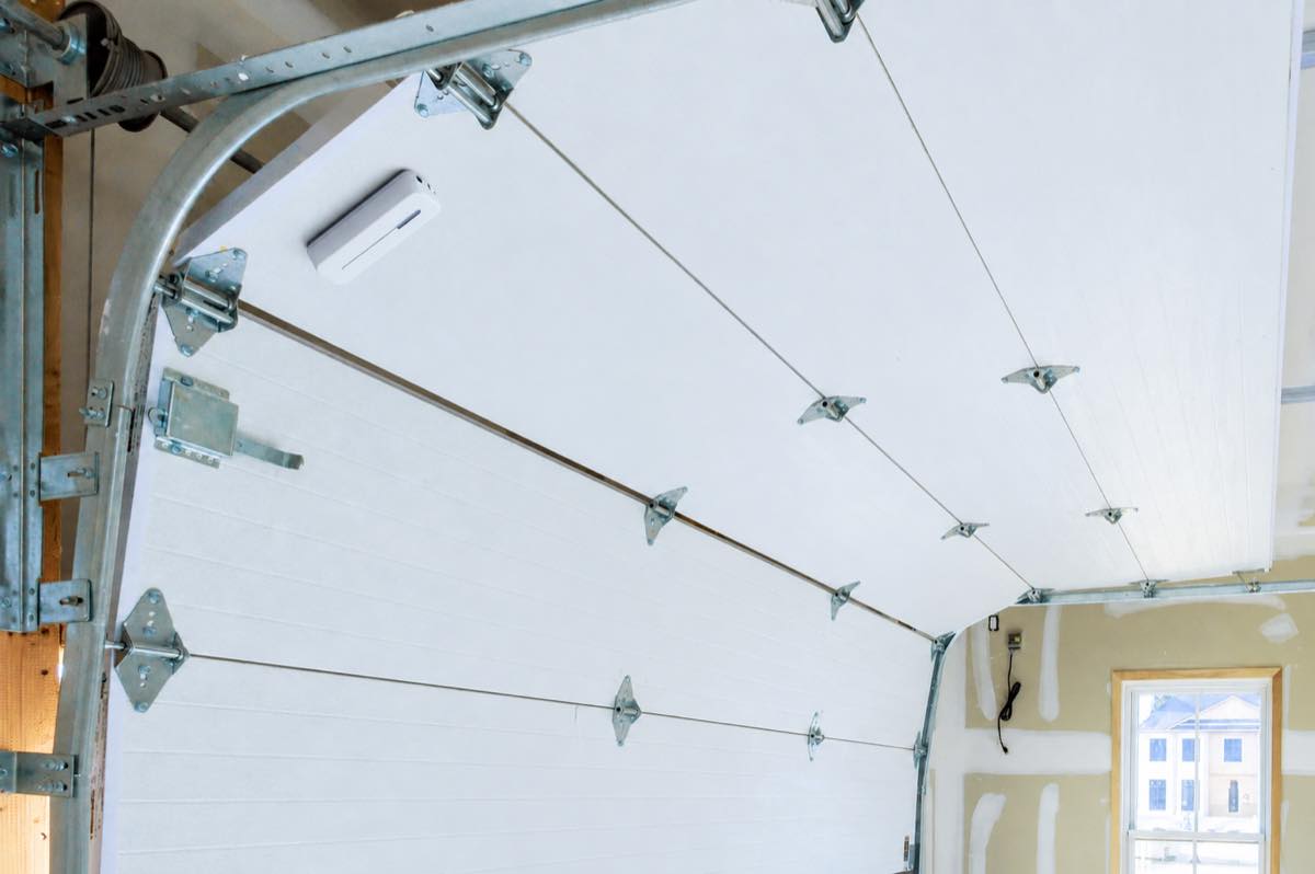 Abode Garage Tilt Sensor mounted inside an overhead garage door