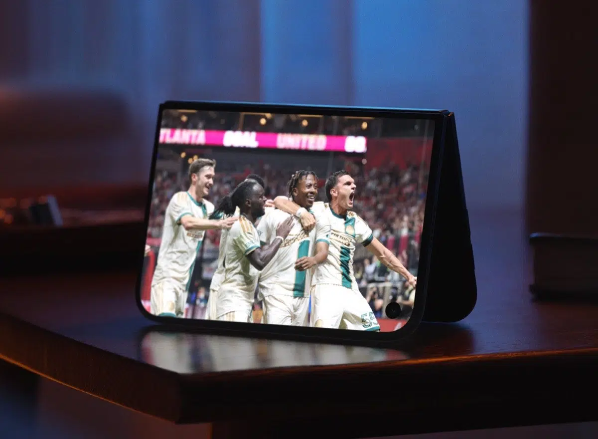 iPhone Duo standing on a table while showing a sports match