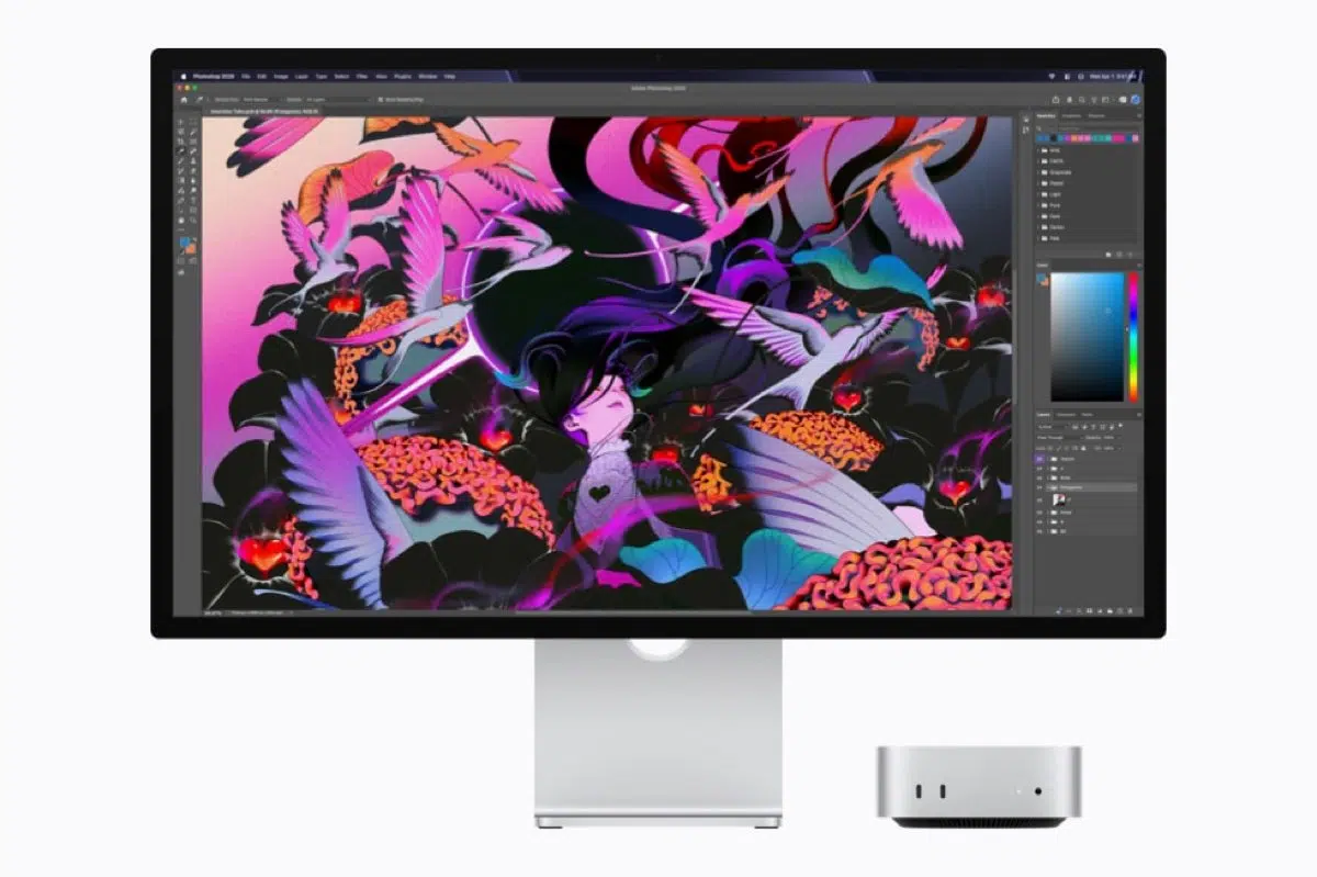Apple Mac mini beside a display running Photoshop.